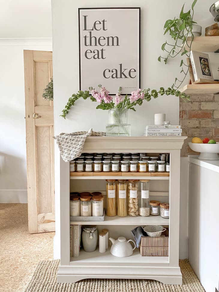 Open shelves in kitchen with organized canisters and jars