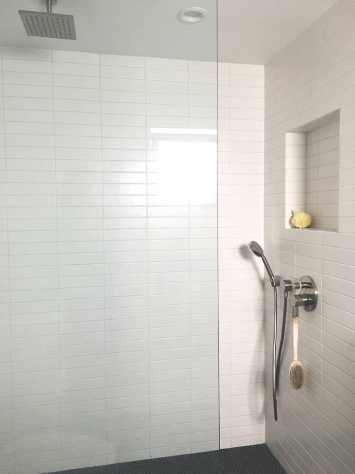 white tiled shower with glass door