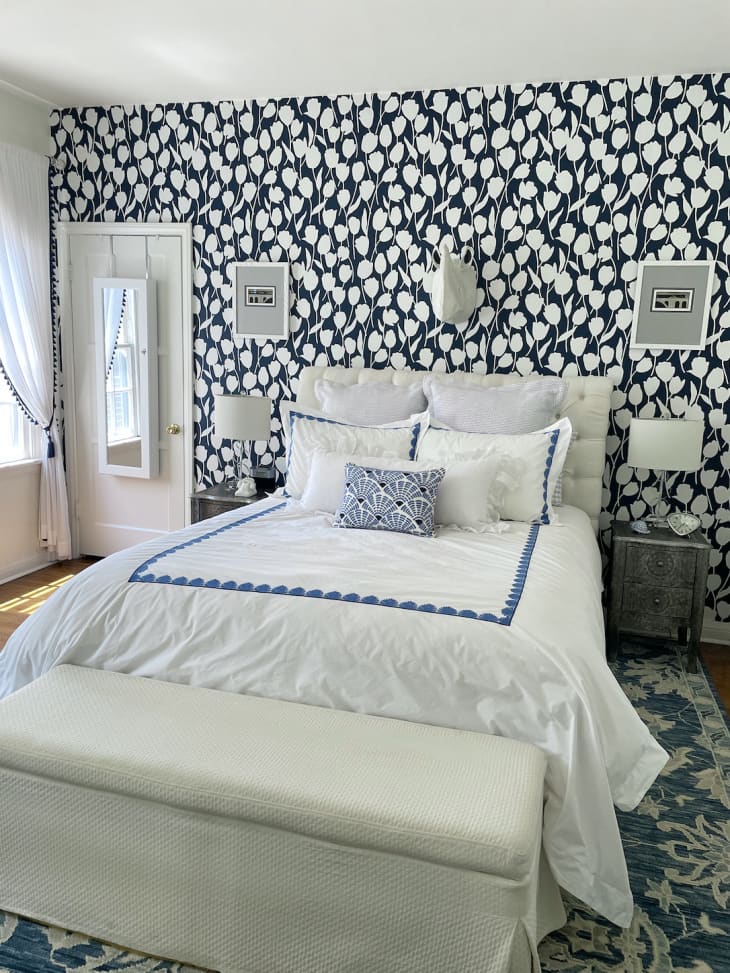 white bedroom with navy blue and white tulip wallpaper accent wall
