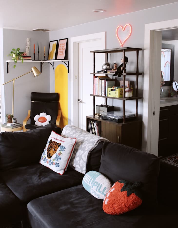 gray studio apartment living space with black velvet sofa