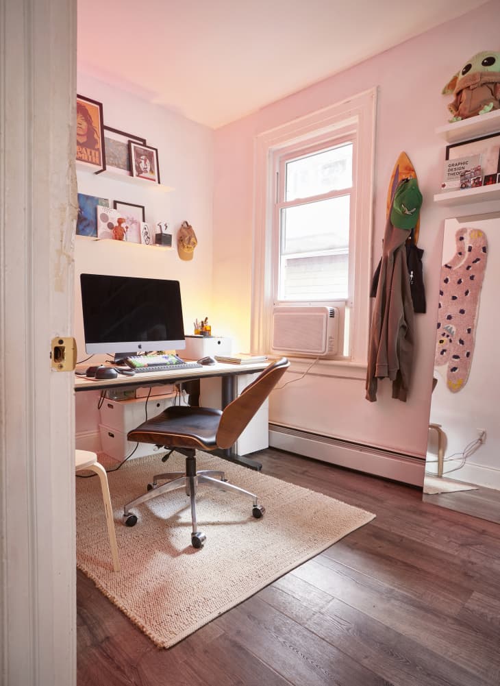 White workspace area with computer desk and pink light