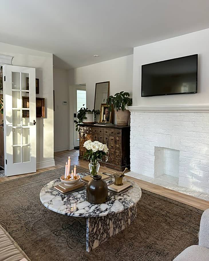 White painted fireplace in newly renovated living room.