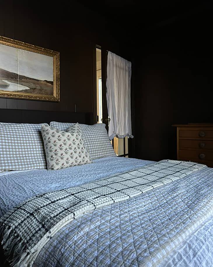 Mix-matched bed linen on bed in newly remodeled bedroom.