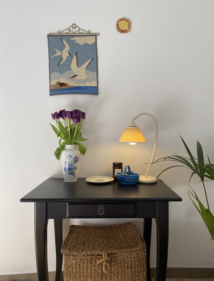 small accent table with lamp and vase of tulips
