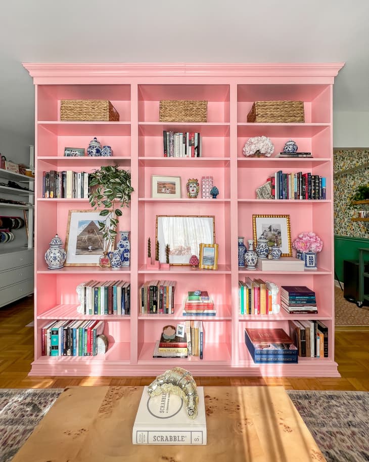 A large built-in pink bookshelf