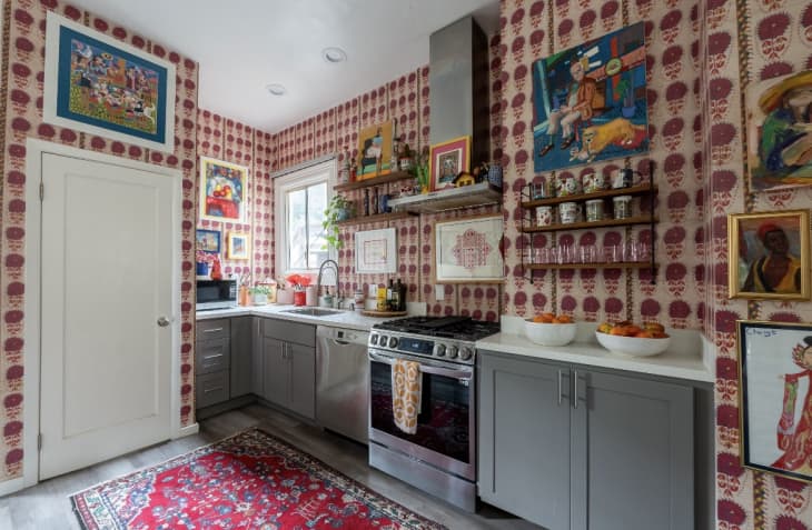Kitchen with floral wallpaper and lots of art
