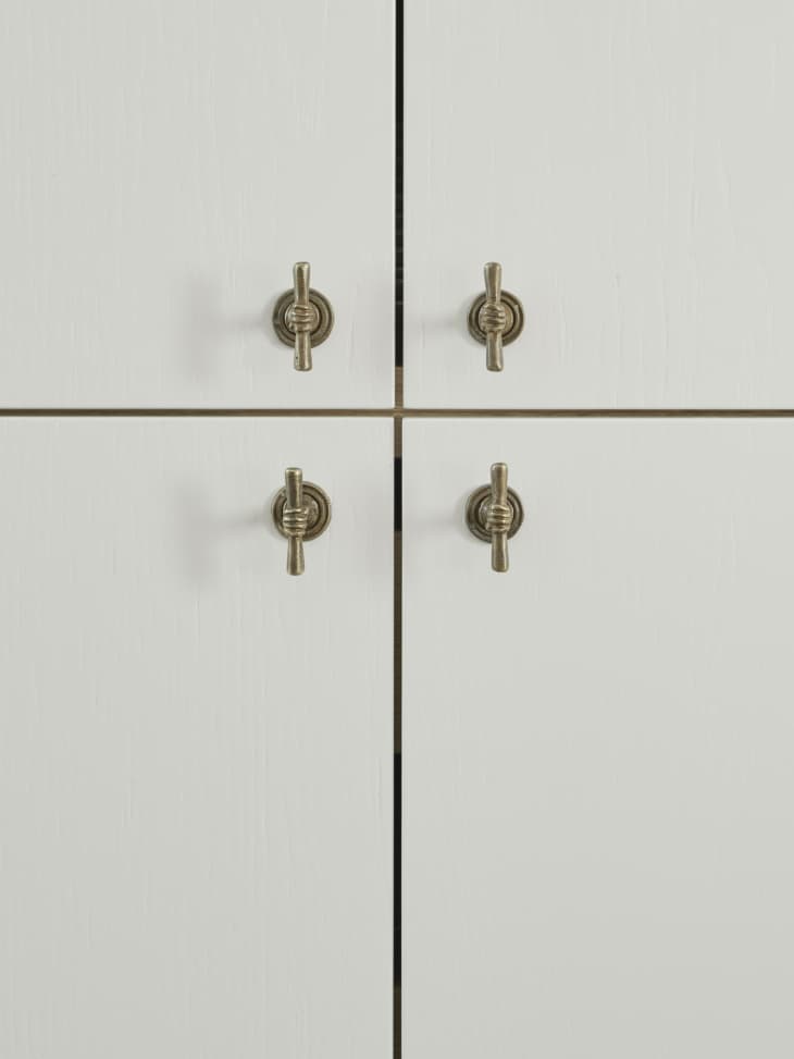 close up on white cabinets with gold knobs