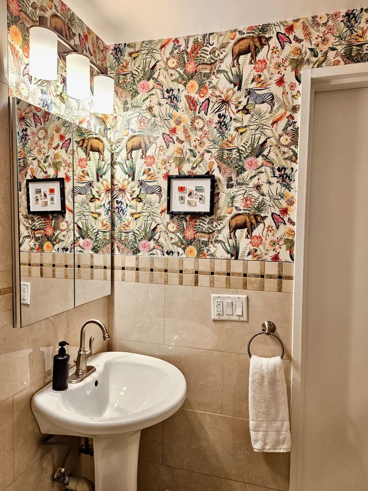 beige bathroom with tile walls and animal/botanical print wallpaper