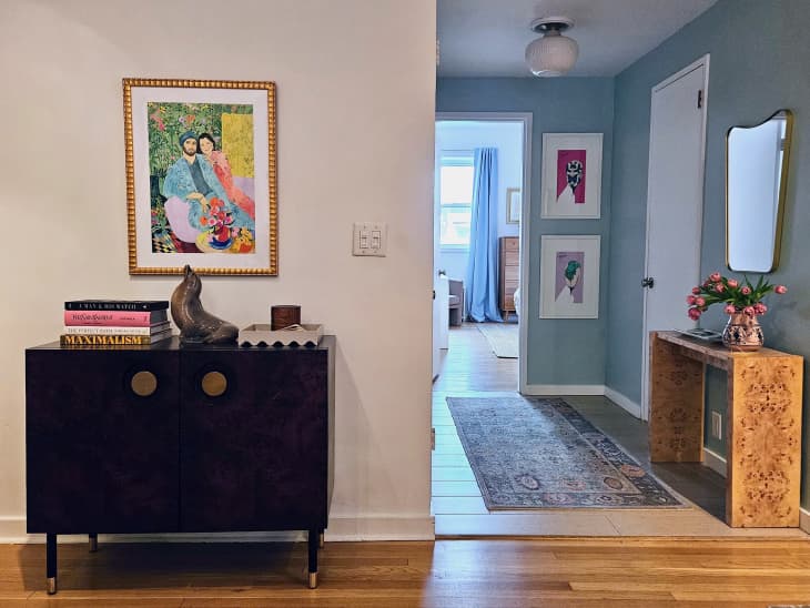 blue entry way with art, mirror, console table