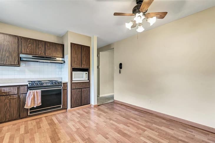 beige outdated kitchen with wood cabinets before remodel