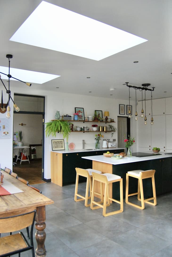 Kitchen with large skylights lighting up cooking and dining areas.