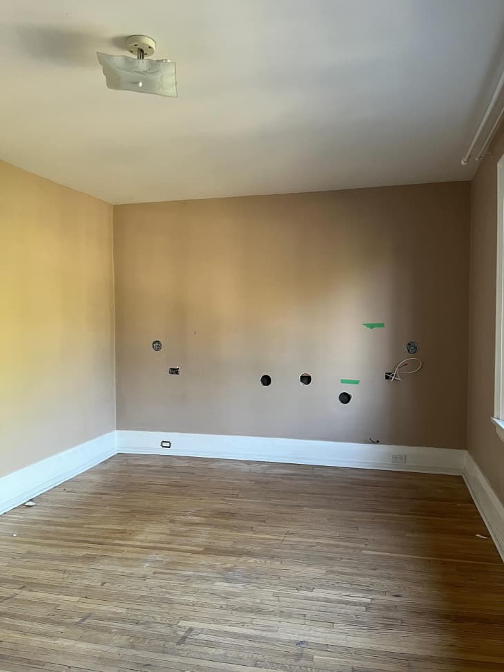 Living room with holes in the wall.