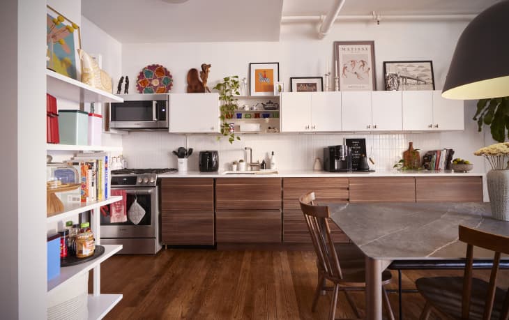 Wooden lower cabinets in apartment kitchen.
