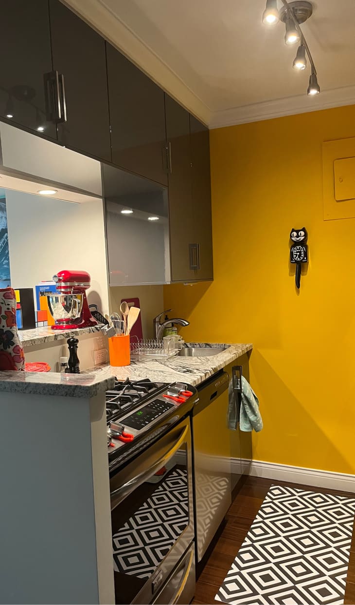 Yellow kitchen with black and white runner rug
