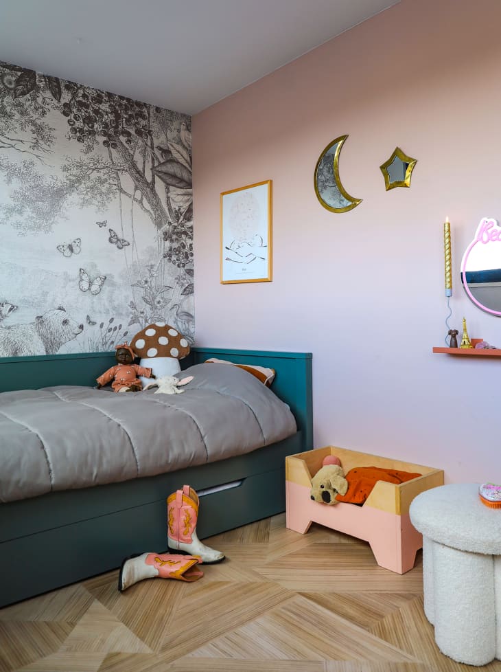 Daybed placed against pink wall in child's bedroom.