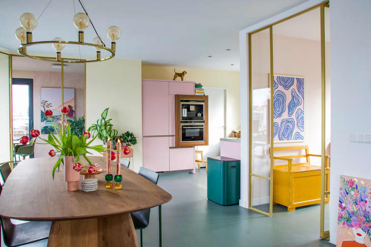 Pastel dining room and kitchen seen in houseboat.