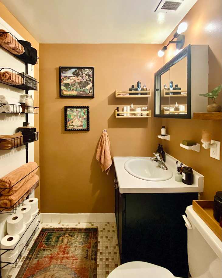 Medium brown bathroom with black cabinets and hanging storage