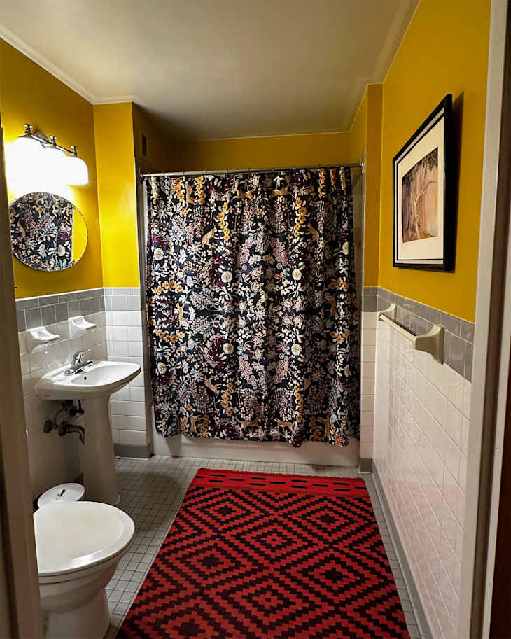 Floral shower curtain in newly renovated bathroom.