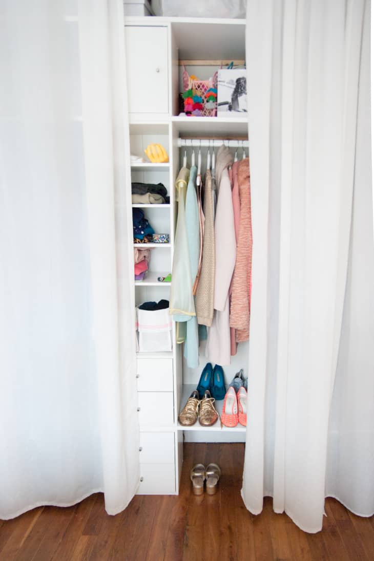 Narrow closet with shelves, dresser, and hanging rack