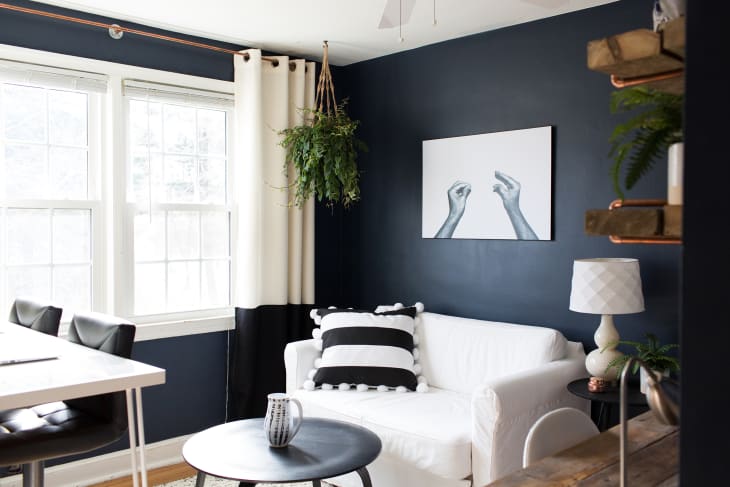 living room with white and black window treatments