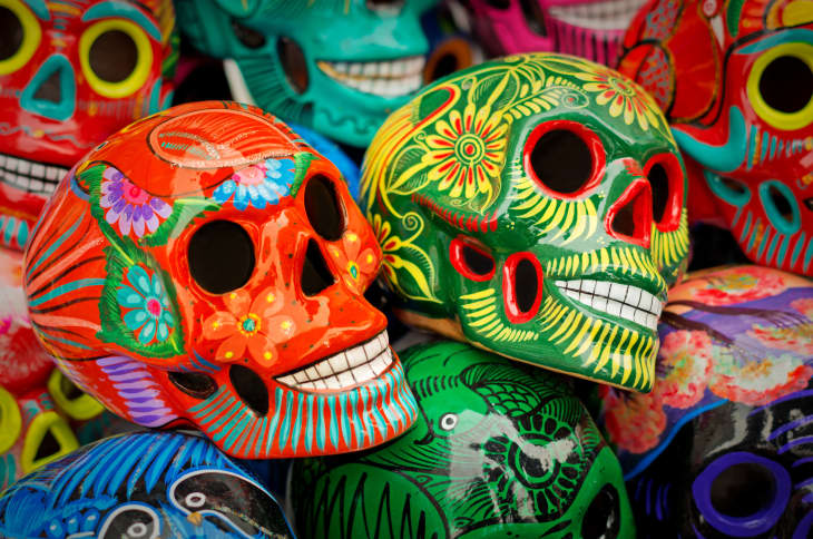 Decorated colorful skulls, ceramics death symbol at market, day of dead, Mexico