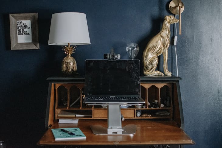 home workspace with deep blue walls, wood desk