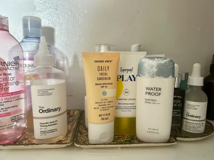 Bathroom tray filled with skincare, including Trader Joe's sunscreen.