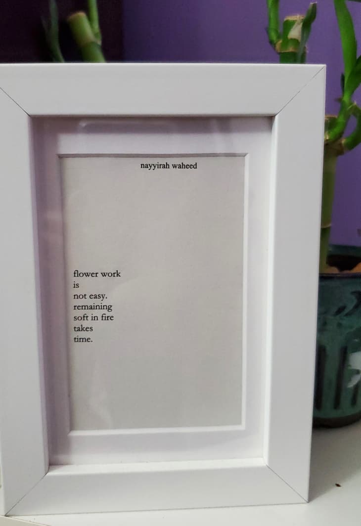 A poem by Nayyirah Waheed mounted inside a white frame