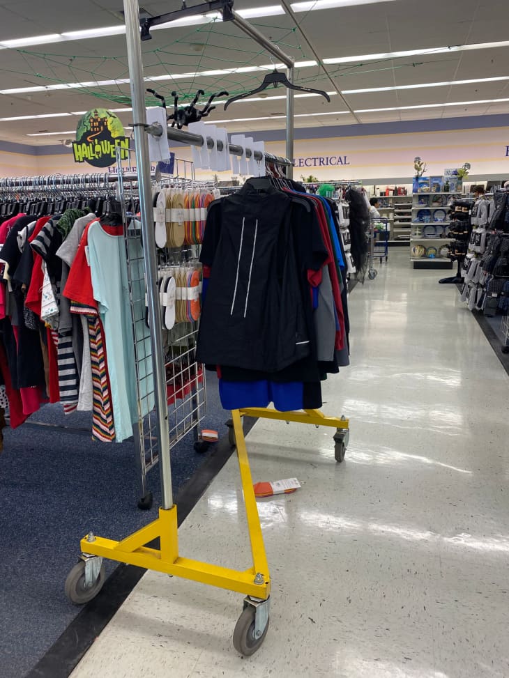 clothing rack on wheels at a thrift store