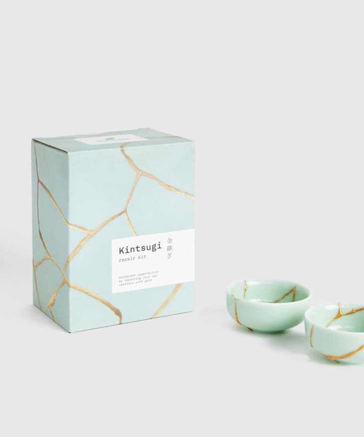 Mint-green repair kit box and ceramics with gold accents