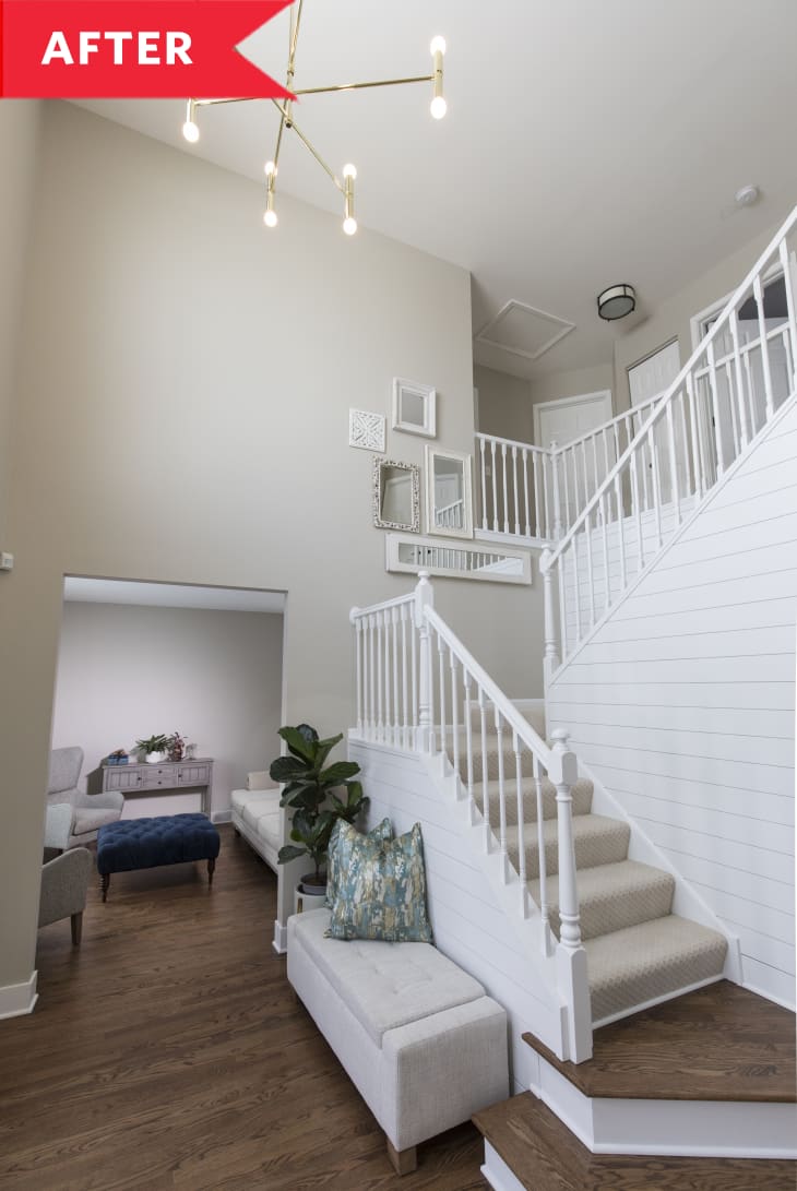 After: White stairwell with modern light fixture