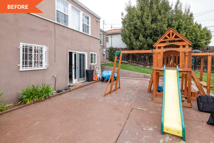 clay colored house and sidewalk with wooden jungle gym