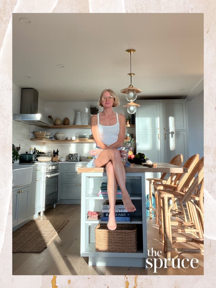 A woman sitting on a kitchen island