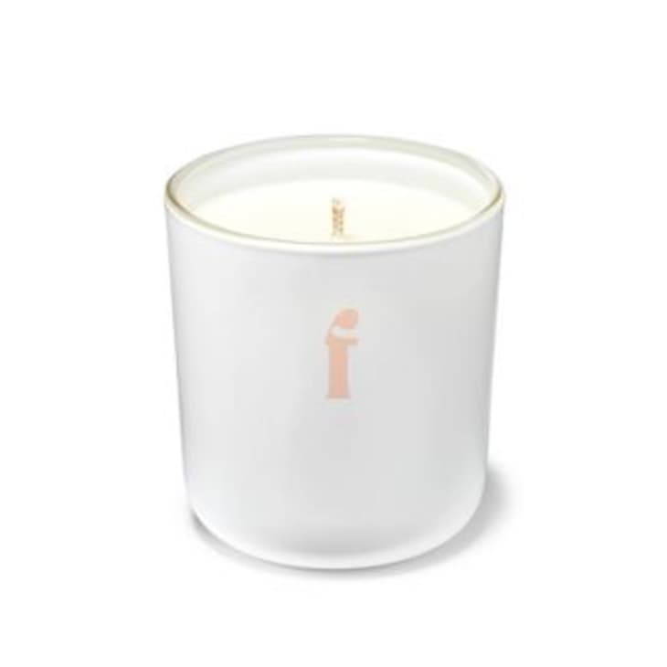 white candle with pink 'f' on the jar