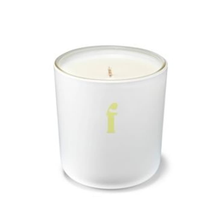 White candle with a yellow 'f' on the jar