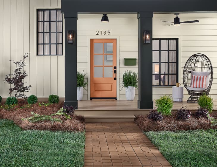 Front door of home featuring HGTV Home by Sherwin-Williams paint color Persimmon