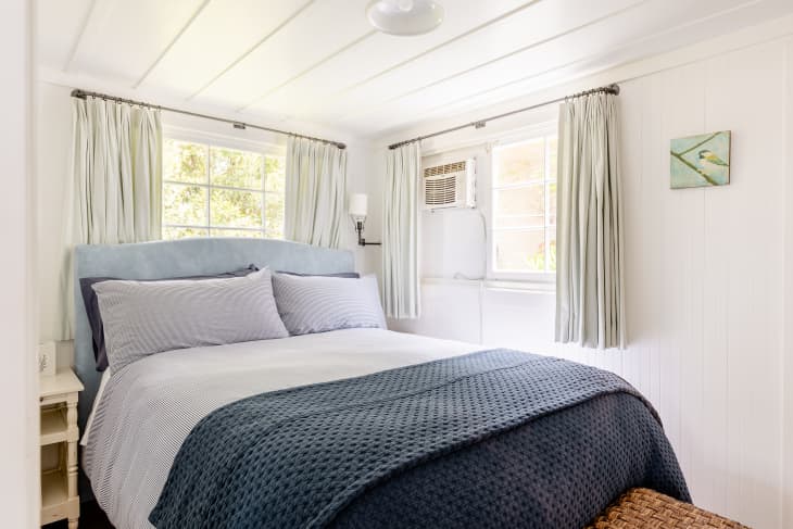 white bedroom with blue accents in Mila Kunis' and Ashton Kutcher's Santa Barbara Airbnb