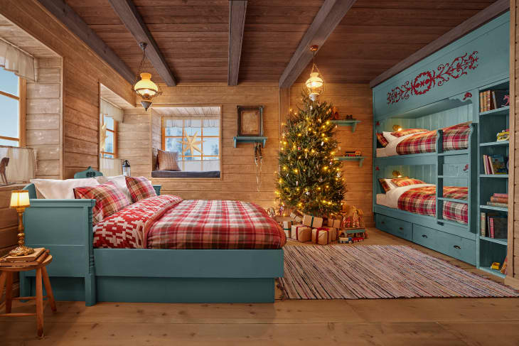 wood walls, ceiling, and floor with teal blue wood bed and built in bunk beds, christmas tree in corner