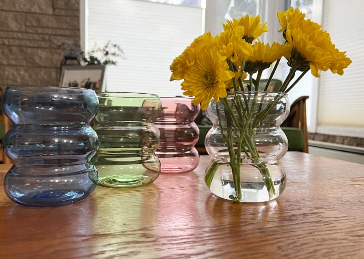 4 colors of target's glass bubble vase, one with flowers, on table