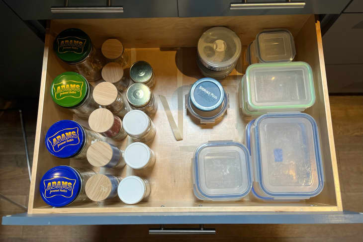 Tupperware in kitchen drawer being organized using Boundary Decluttering method.