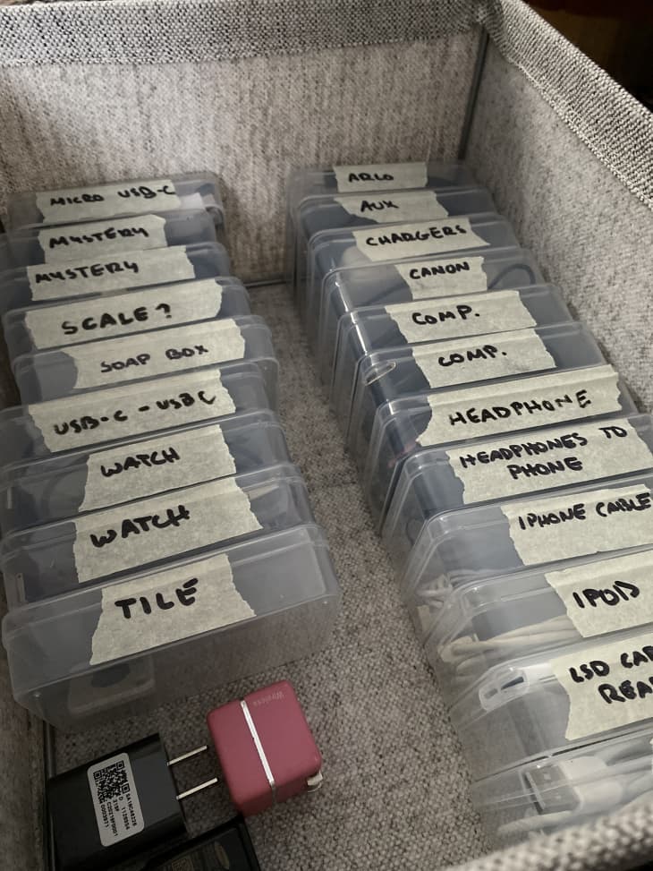 fabric bin full of smaller labeled containers with different cords