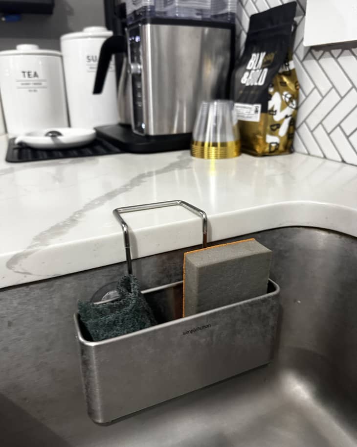 simplehuman sink caddy holding sponges in stainless steel kitchen sink