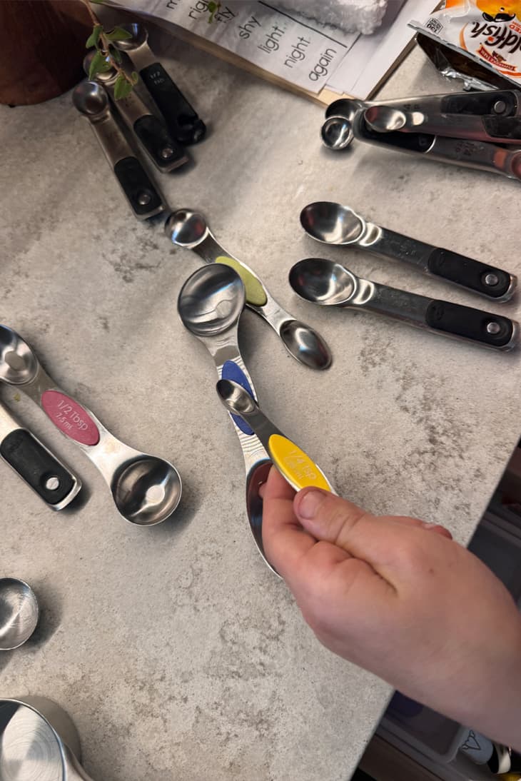 Metal measuring spoons laid out on counter