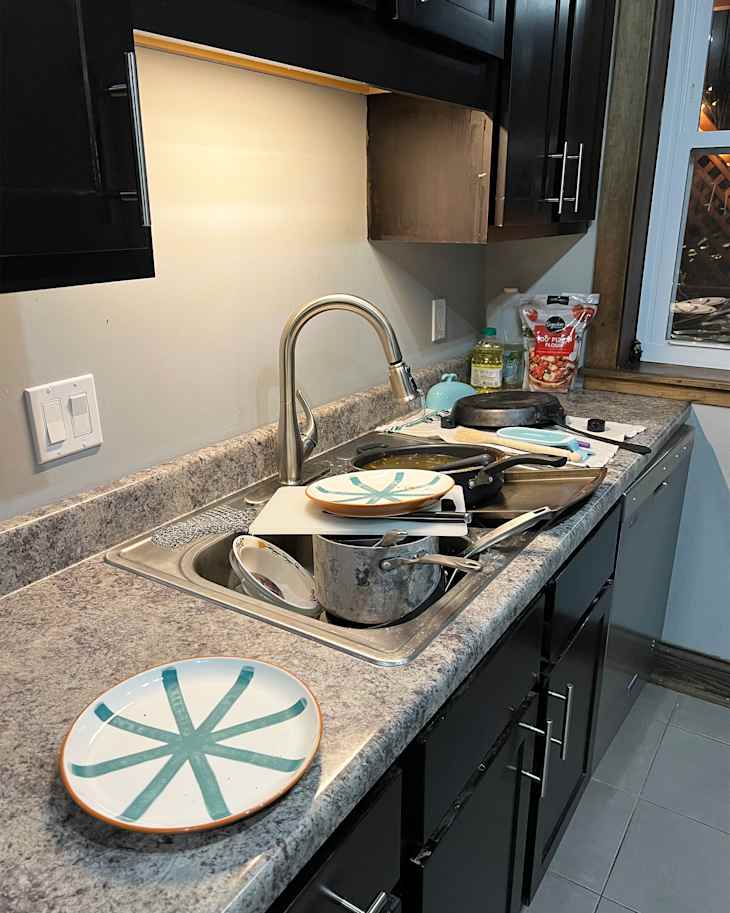 Kitchen sink filled with dishes.