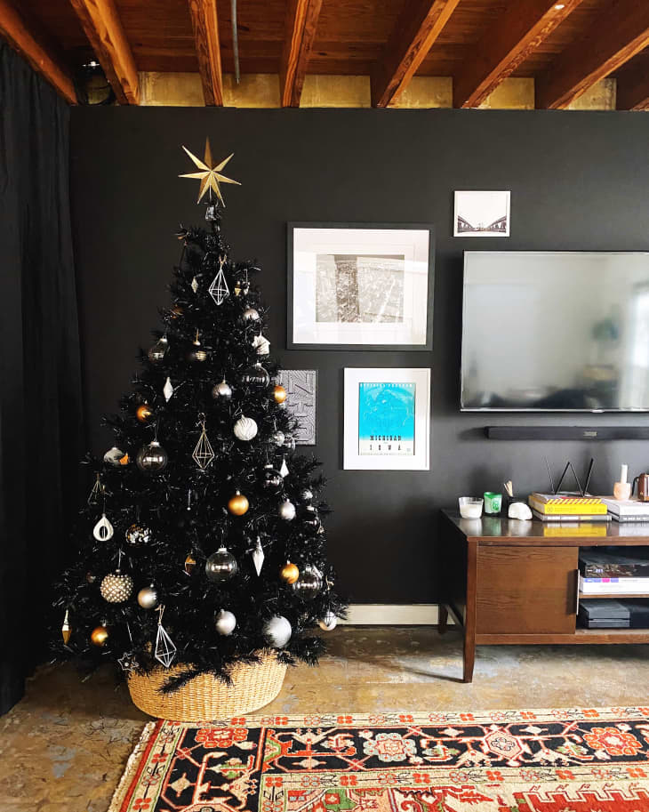 A black Christmas tree in a black living room.