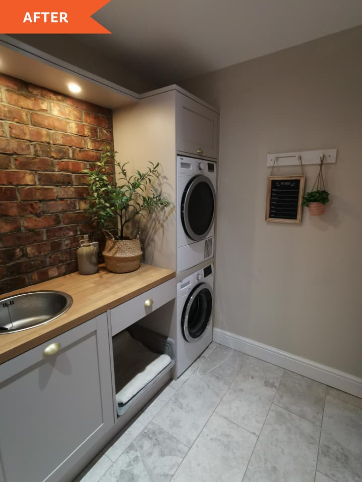 After: laundry room with exposed brick, stacked washer and dryer, and wooden counter space