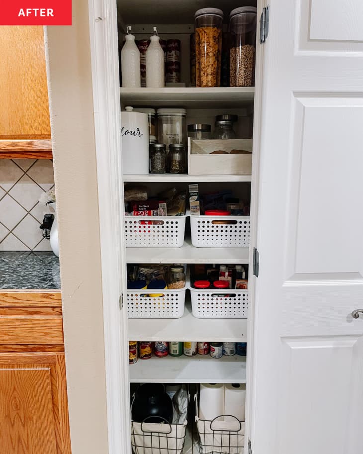 Pantry after organizing: good are organized by type, white bins are in place to hold like items, create a more organized look