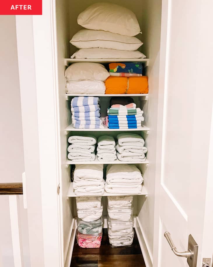 Linen closet after being organized, shelves arranged by linen type, things nicely folded, etc
