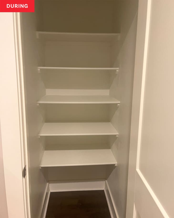 linen closet during reorganization: all shelves have been cleared, closet is empty