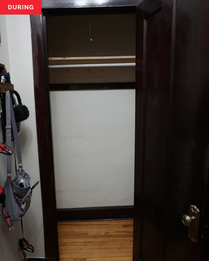 During: An empty closet with a brown wooden door